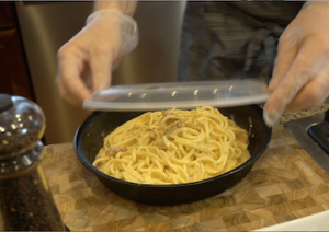 fresh spaghetti in takeout container for delivery